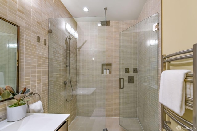 bathroom featuring a shower stall, vanity, and recessed lighting