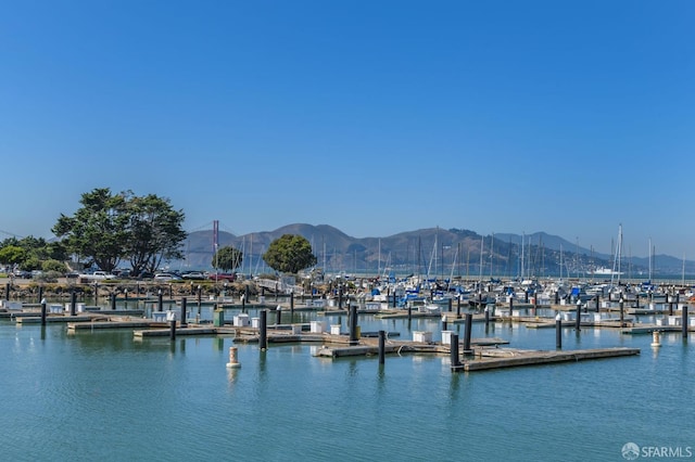 view of dock featuring a water and mountain view