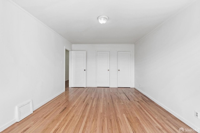 unfurnished bedroom featuring light hardwood / wood-style flooring and a closet