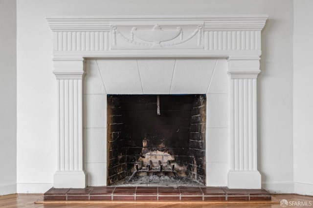 interior details featuring hardwood / wood-style floors and a fireplace