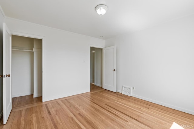 unfurnished bedroom featuring a closet and light hardwood / wood-style floors