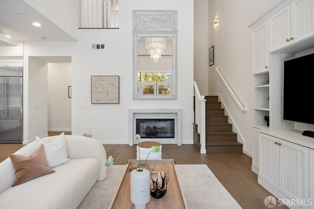 16 Barneson Ave, San Mateo, CA 94402 - living room with a glass covered fireplace, stairs, dark wood-style flooring, a high ceiling, and baseboards