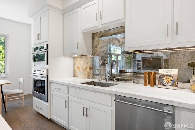 16 Barneson Ave, San Mateo, CA 94402 - kitchen featuring appliances with stainless steel finishes, a sink, backsplash, dark wood-style flooring, and white cabinets