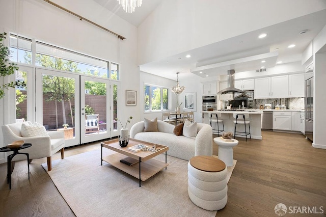 16 Barneson Ave, San Mateo, CA 94402 - living room featuring a chandelier, light wood-style flooring, a high ceiling, and recessed lighting