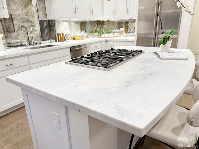 16 Barneson Ave, San Mateo, CA 94402 - kitchen with a sink, a center island, stainless steel appliances, decorative backsplash, and light wood-style floors