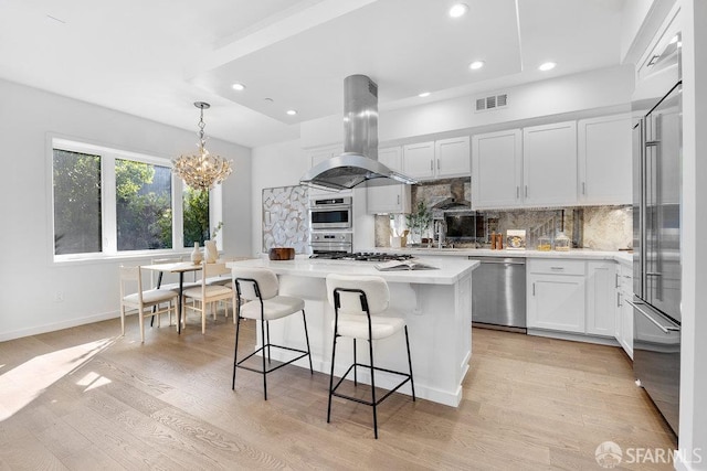 16 Barneson Ave, San Mateo, CA 94402 - kitchen with appliances with stainless steel finishes, island exhaust hood, recessed lighting, decorative backsplash, and a center island