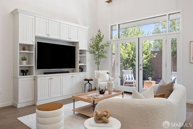 16 Barneson Ave, San Mateo, CA 94402 - living room featuring wood finished floors, healthy amount of natural light, a high ceiling, baseboards, and french doors