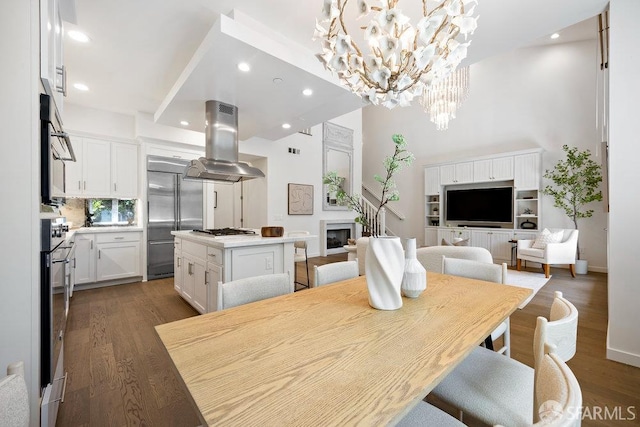 16 Barneson Ave, San Mateo, CA 94402 - dining space with a chandelier, wood finished floors, a towering ceiling, a fireplace, and recessed lighting
