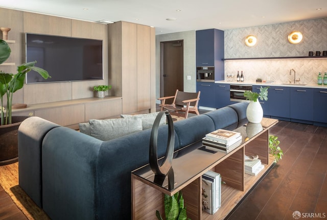 living room featuring wet bar and dark wood-type flooring