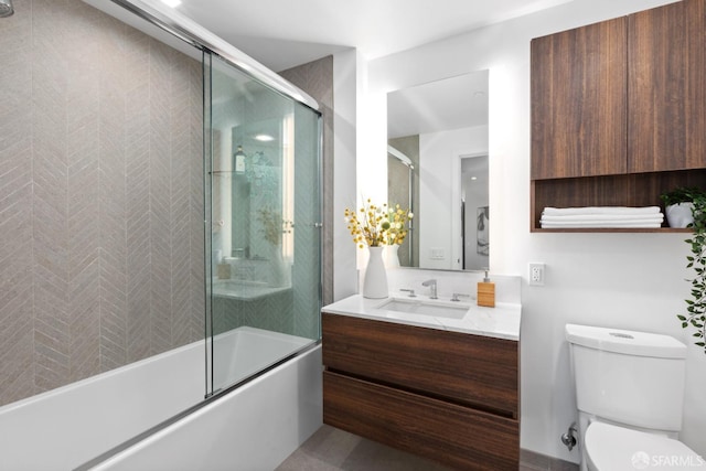 full bathroom featuring shower / bath combination with glass door, vanity, and toilet