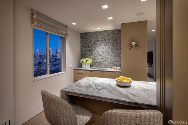 dining space featuring sink and light hardwood / wood-style flooring