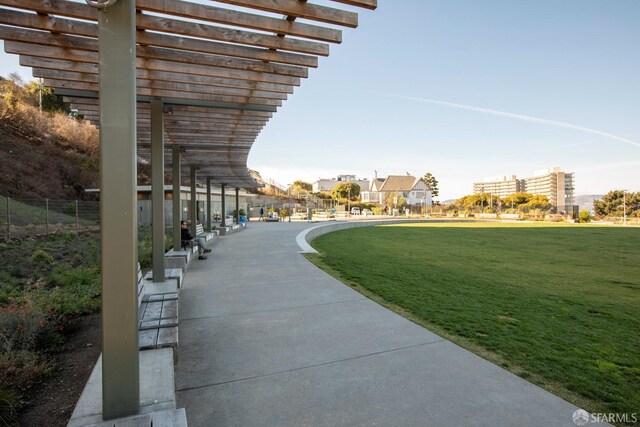 view of home's community featuring a lawn and a pergola