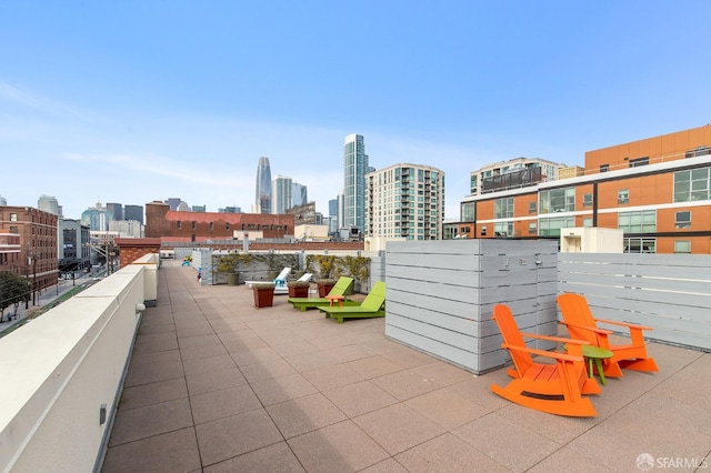 view of patio with a city view and a balcony