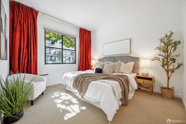 carpeted bedroom with baseboards