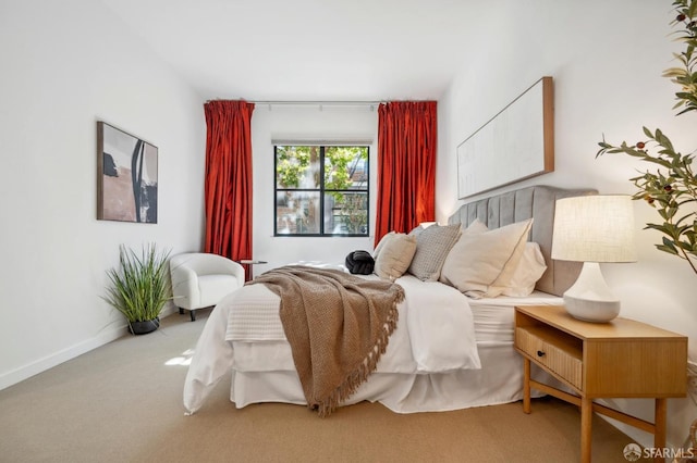 carpeted bedroom featuring baseboards