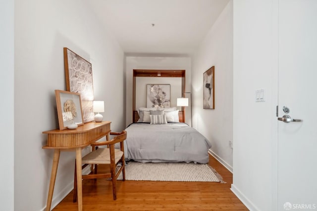 bedroom featuring light wood-type flooring and baseboards