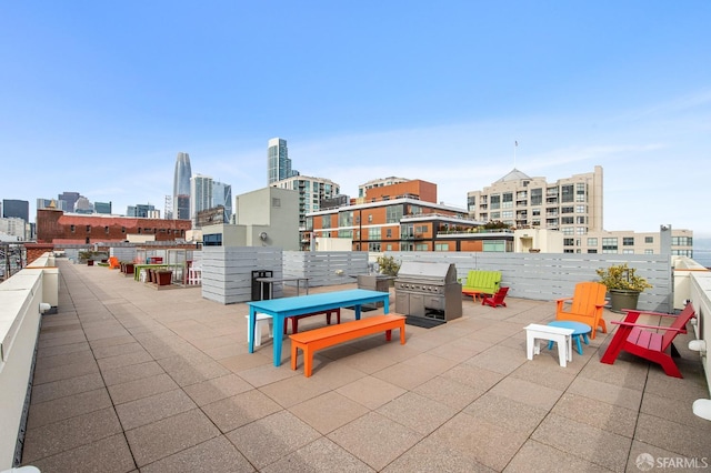 view of patio / terrace featuring a view of city and a grill