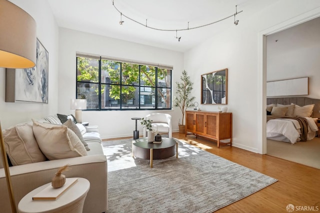 living room featuring wood finished floors and baseboards