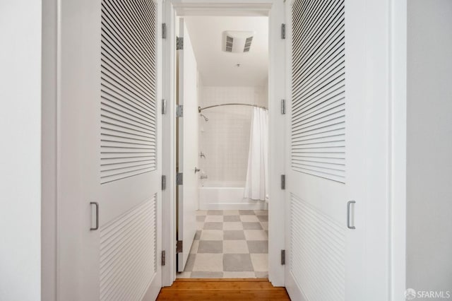 hallway with visible vents and tile patterned floors