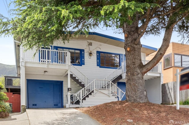 view of front of property with stairway and driveway