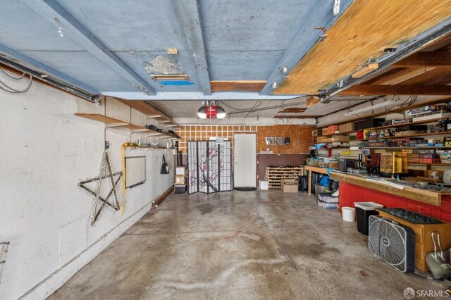garage with a workshop area and a garage door opener