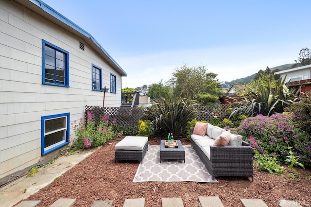 view of patio with outdoor lounge area and fence