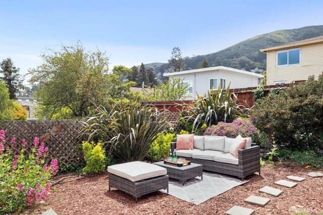 view of yard with an outdoor hangout area, a patio area, a fenced backyard, and a mountain view