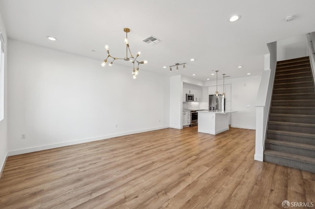 3821 Wattling St, Oakland, CA 94601 - unfurnished living room featuring a chandelier, stairway, recessed lighting, light wood finished floors, and baseboards