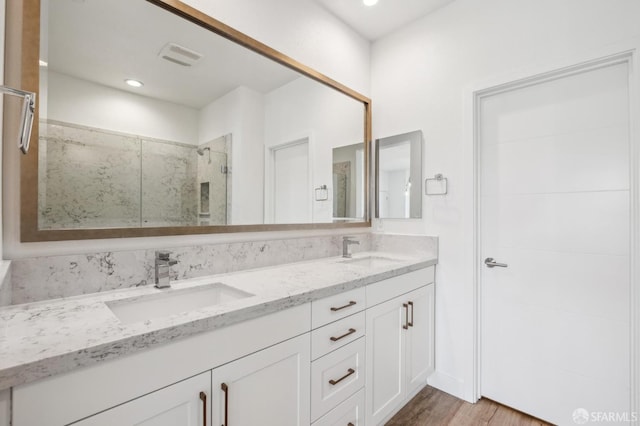 3821 Wattling St, Oakland, CA 94601 - bathroom with a shower stall, double vanity, wood finished floors, and recessed lighting