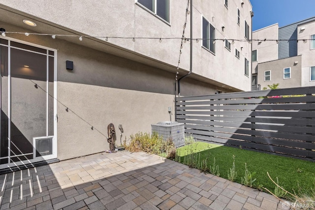 3821 Wattling St, Oakland, CA 94601 - view of property exterior with stucco siding, fence, and a patio