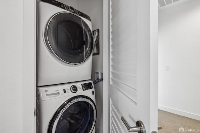 3821 Wattling St, Oakland, CA 94601 - clothes washing area with stacked washer / drying machine, carpet flooring, and baseboards
