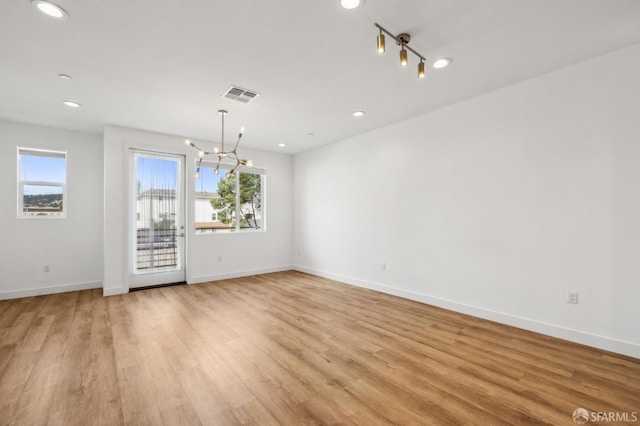 3821 Wattling St, Oakland, CA 94601 - unfurnished dining area featuring plenty of natural light, a chandelier, light wood finished floors, baseboards, and recessed lighting