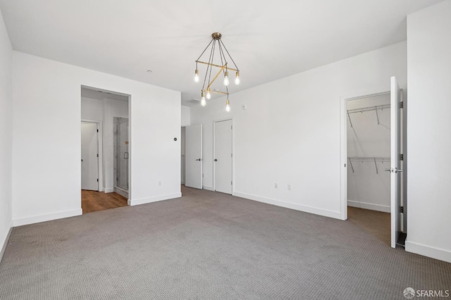3821 Wattling St, Oakland, CA 94601 - unfurnished bedroom with carpet floors, a chandelier, baseboards, and a spacious closet