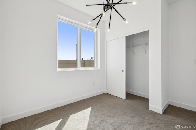 3821 Wattling St, Oakland, CA 94601 - unfurnished bedroom with a chandelier, carpet flooring, a closet, and baseboards