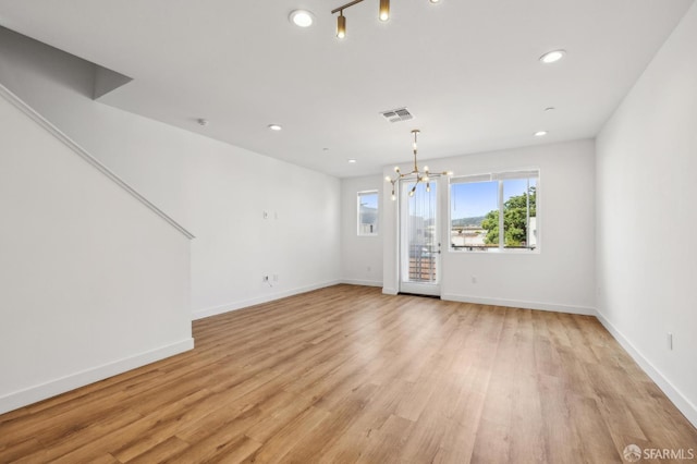 3821 Wattling St, Oakland, CA 94601 - unfurnished dining area with light wood-style floors, a chandelier, recessed lighting, and baseboards
