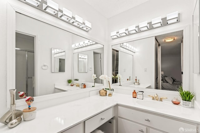 bathroom with walk in shower and vanity