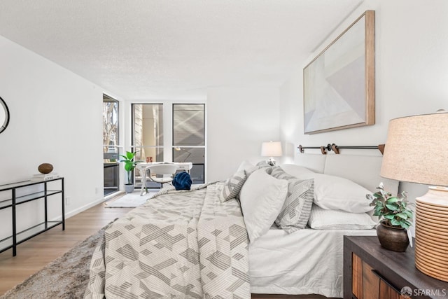 bedroom featuring a textured ceiling and hardwood / wood-style flooring