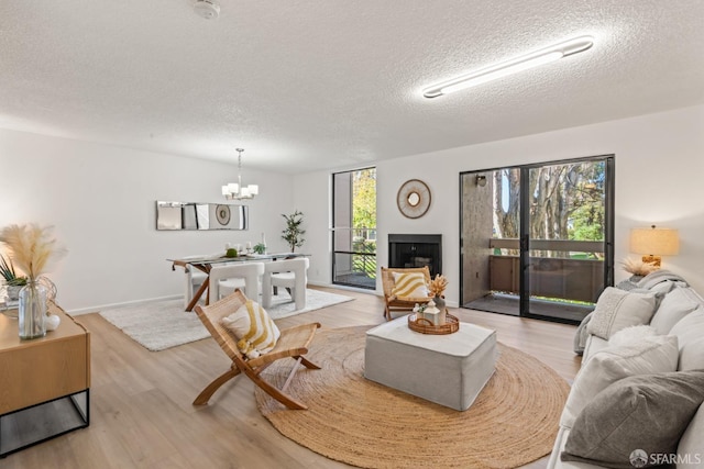 living room with a textured ceiling and light hardwood / wood-style flooring