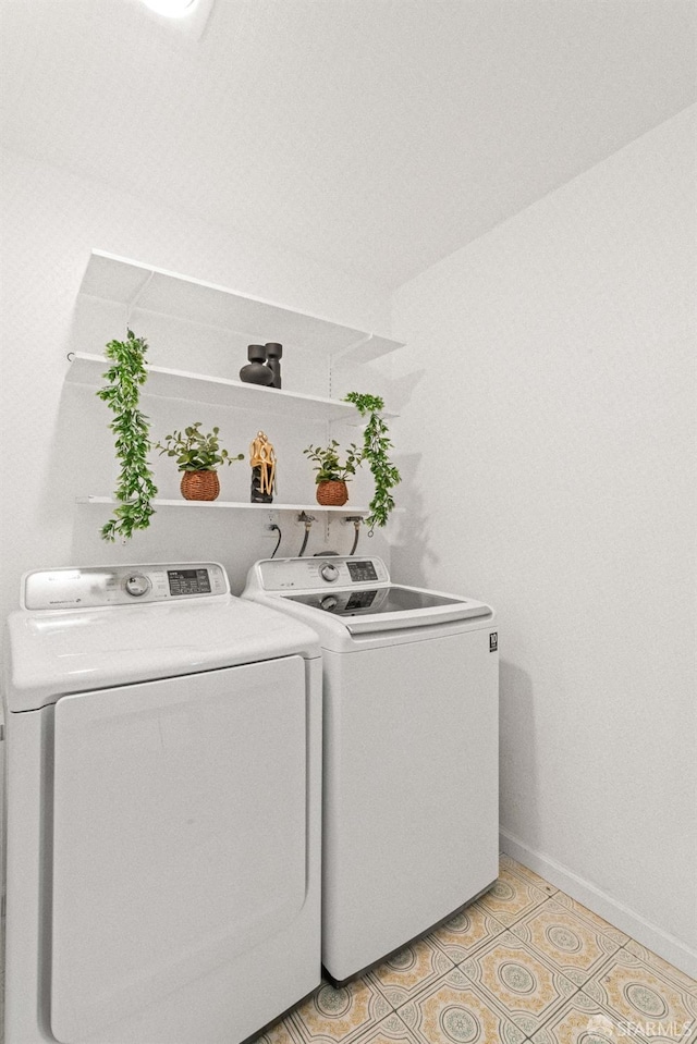 clothes washing area with light tile patterned flooring and independent washer and dryer