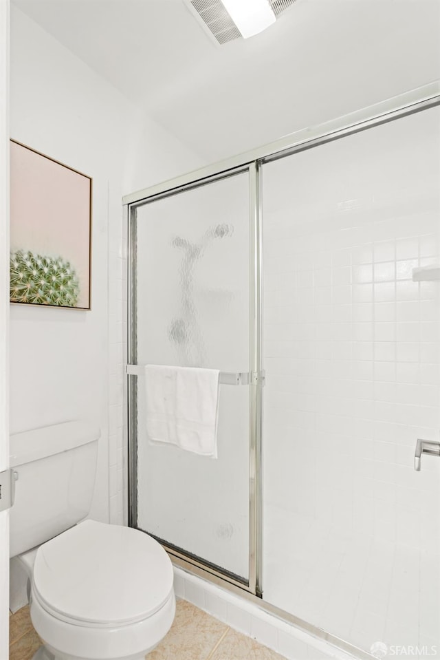 bathroom with an enclosed shower, toilet, and tile patterned flooring