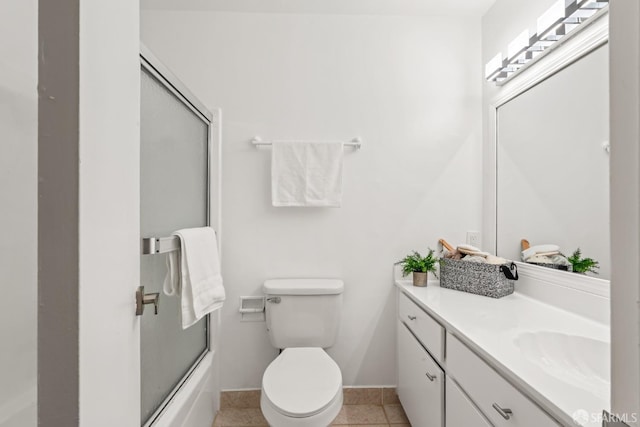 full bathroom with toilet, vanity, tile patterned flooring, and shower / bath combination with glass door