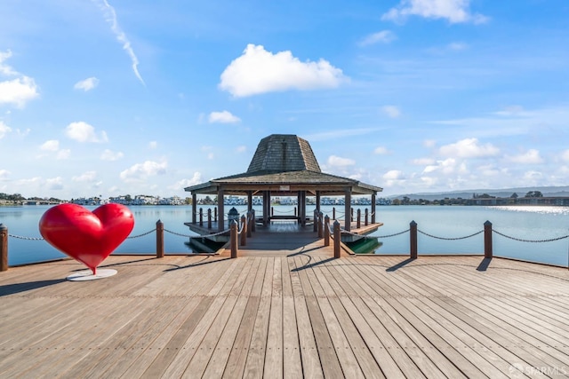 view of dock featuring a gazebo and a water view