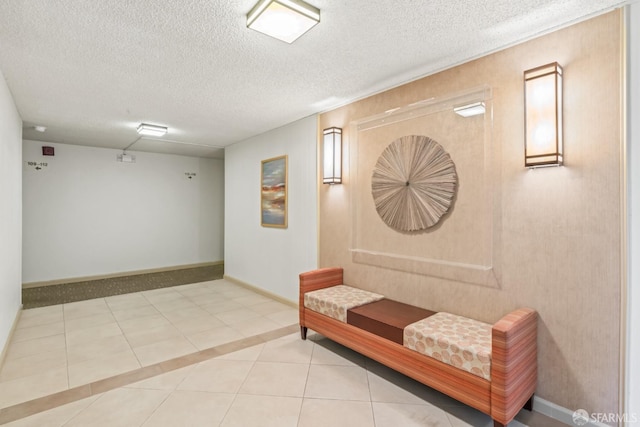 hallway featuring a textured ceiling and light tile patterned floors