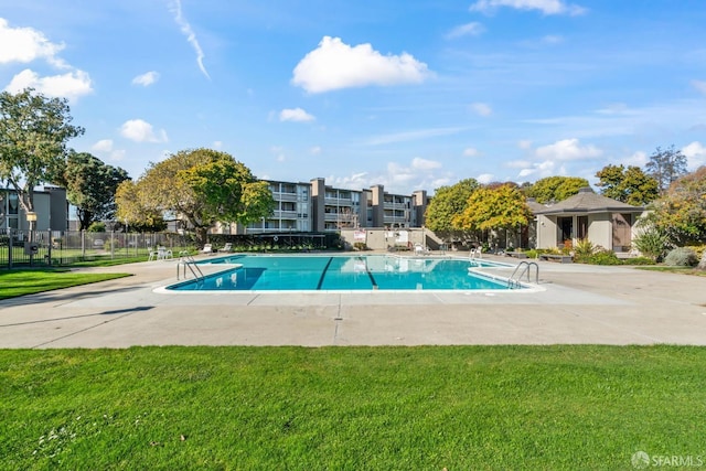 view of pool featuring a yard and a patio