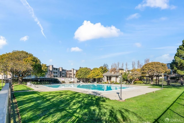 view of pool featuring a yard