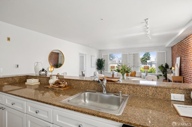323 29th St Unit C301, San Francisco, CA 94131 - kitchen with white cabinets, track lighting, open floor plan, and dark stone counters