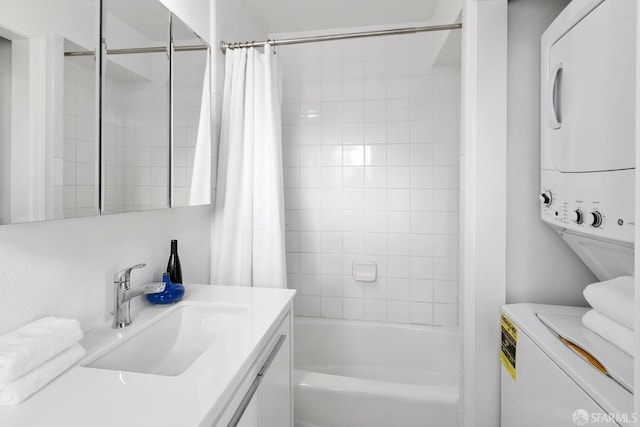 full bath featuring vanity, stacked washer and dryer, and shower / bath combo