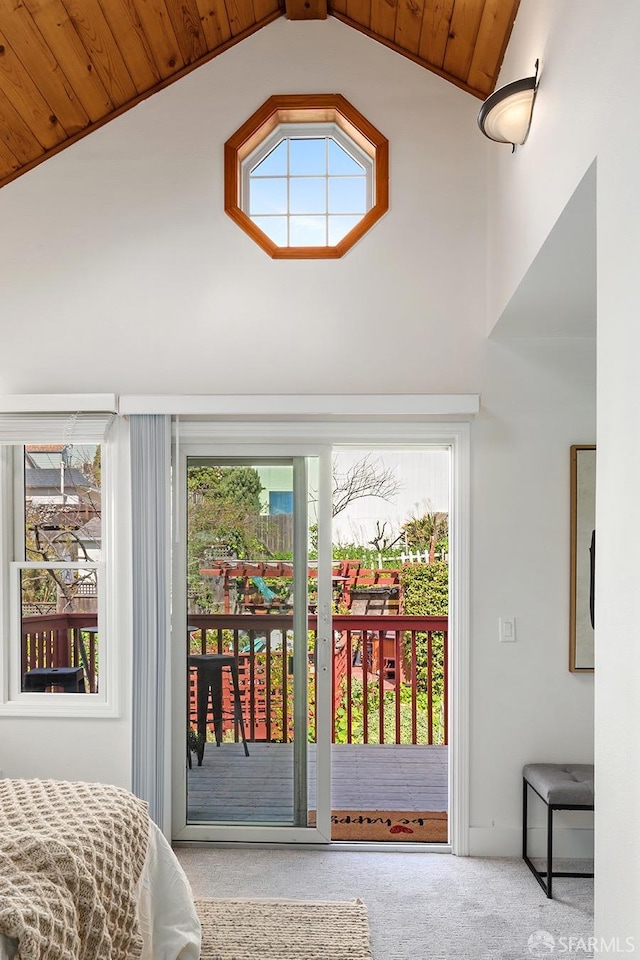 bedroom featuring access to exterior, wooden ceiling, carpet floors, and high vaulted ceiling