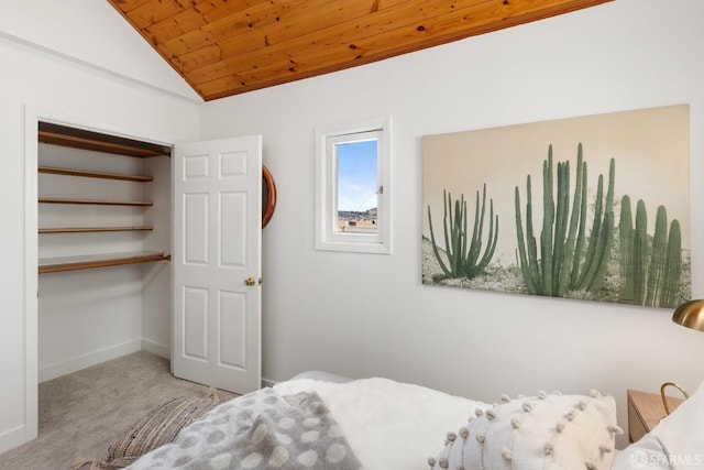 carpeted bedroom featuring lofted ceiling, wood ceiling, and baseboards