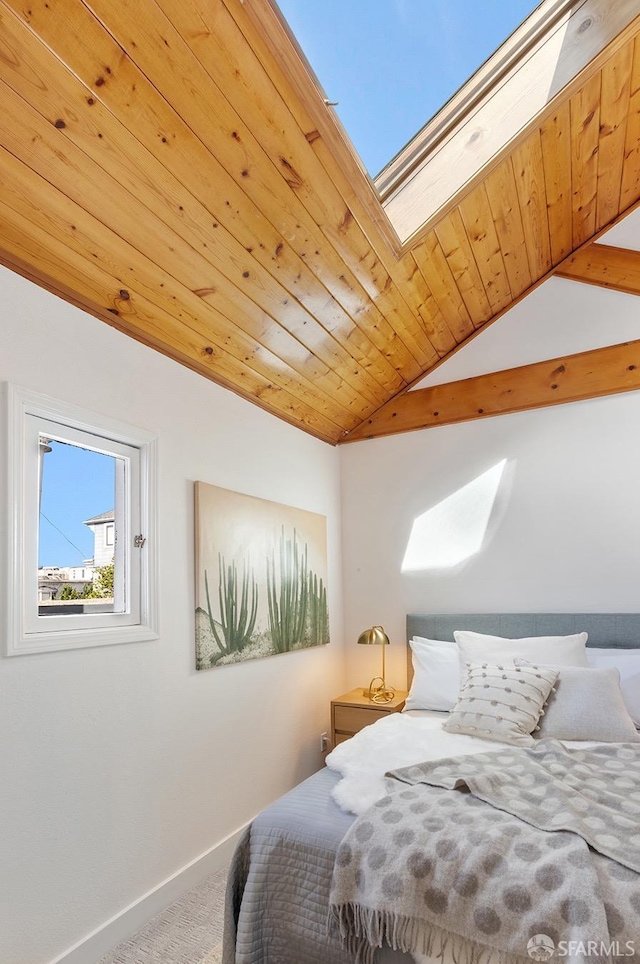 bedroom with vaulted ceiling with skylight, carpet flooring, wood ceiling, and baseboards